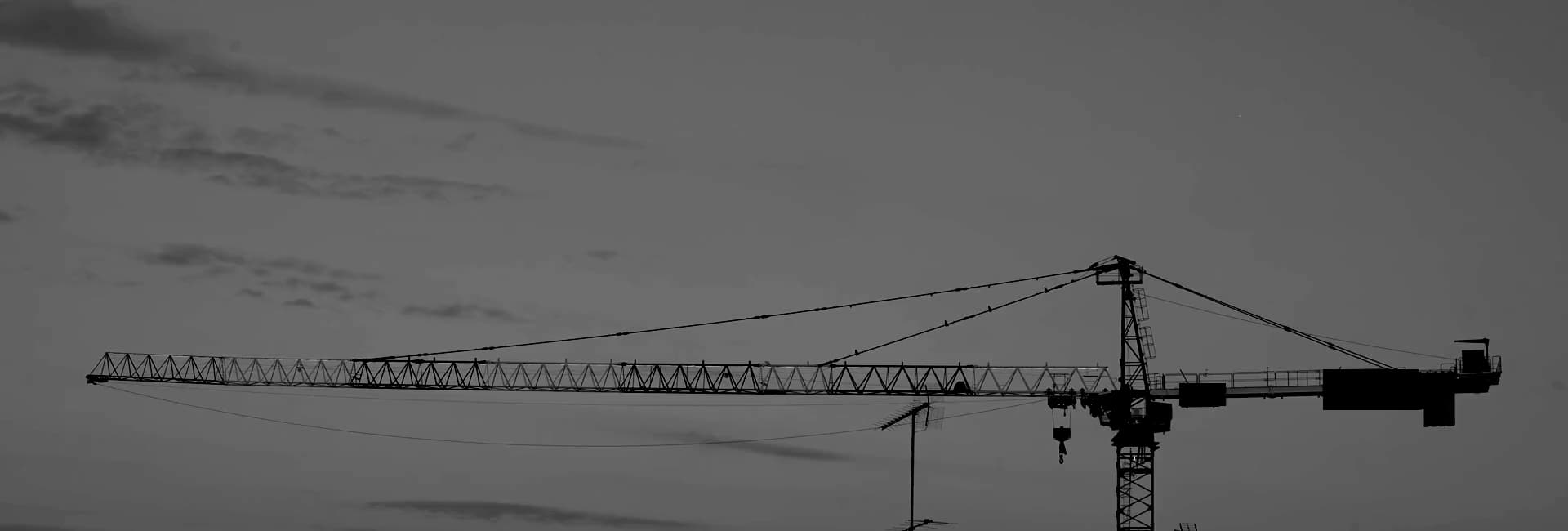A tower crane against the evening sky